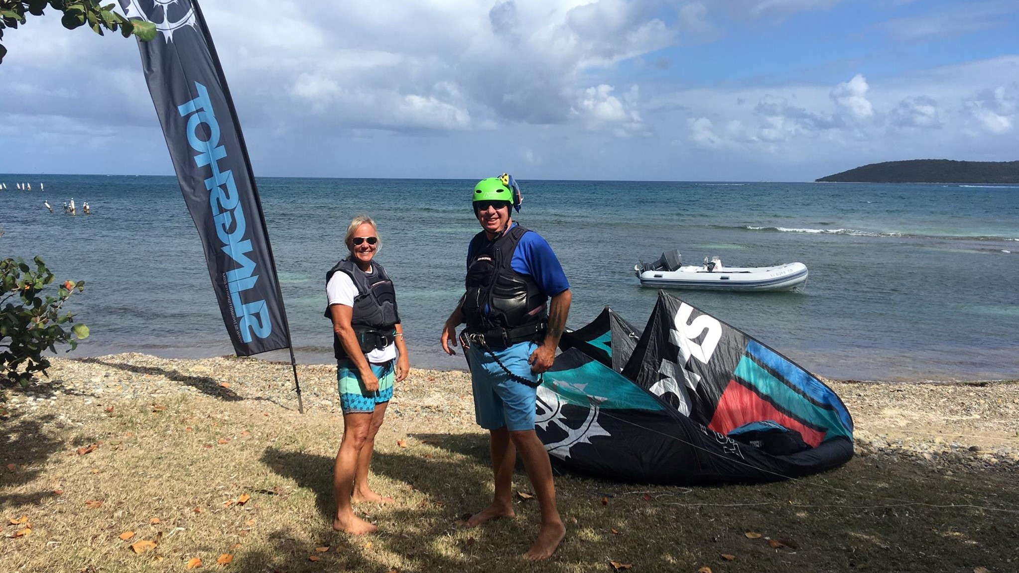 Husband and wife on the beach at kite st croix after a great kitesurfing lesson.